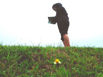 Woman on field against sky