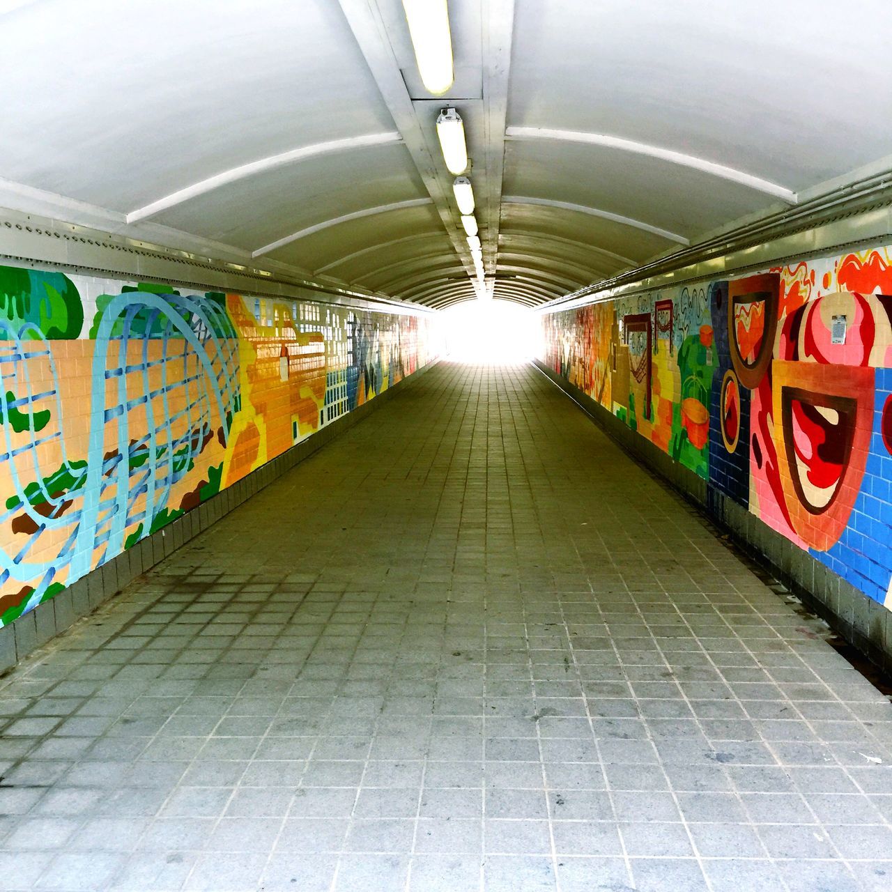 graffiti, indoors, art, ceiling, wall - building feature, creativity, art and craft, multi colored, the way forward, architecture, built structure, diminishing perspective, street art, wall, text, tunnel, illuminated, vanishing point, empty, subway