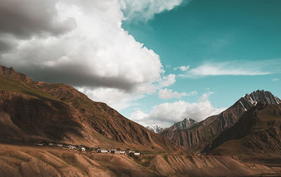 Scenic view of mountains against cloudy sky