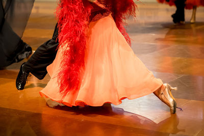 Low section of woman standing in city