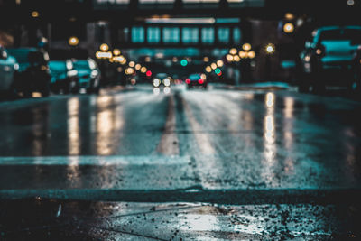 Illuminated city street during rainy season at night