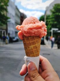 Close-up of hand holding ice cream cone