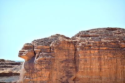 Low angle view of rock formation against clear sky