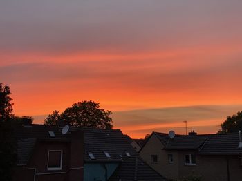 Silhouette buildings against sky during sunset