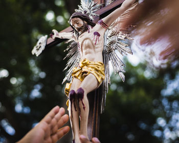 Low angle view of woman holding rope