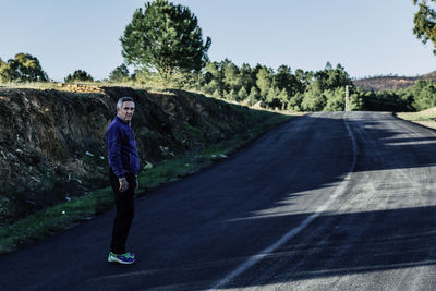 Portrait of senior man standing on road