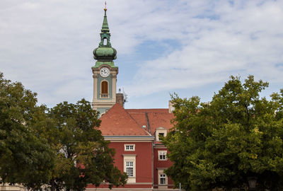 View of building and trees against sky