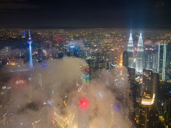 High angle view of illuminated cityscape at night