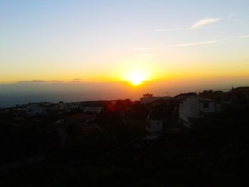 View of city against sky during sunset