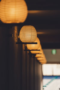 Low angle view of illuminated lanterns in corridor