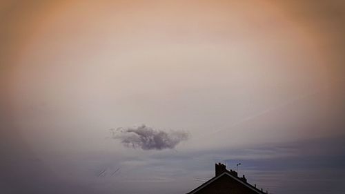 High section of factory against sky at sunset