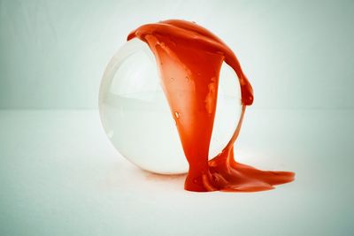 Close-up of orange on table against white background