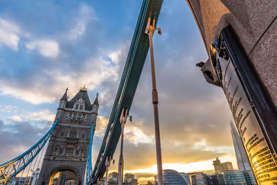 Low angle view of buildings against cloudy sky