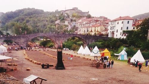 Group of people in town against buildings in city