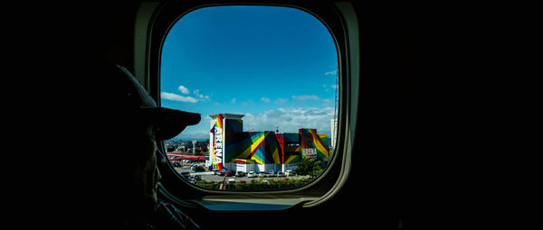 Man seen through airplane window