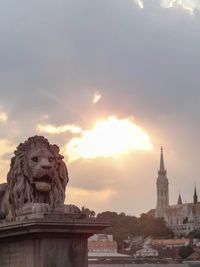 Silhouette of building against cloudy sky