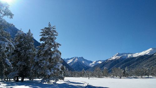 Scenic view of snowcapped mountains against clear blue sky