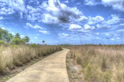 Empty road along countryside landscape