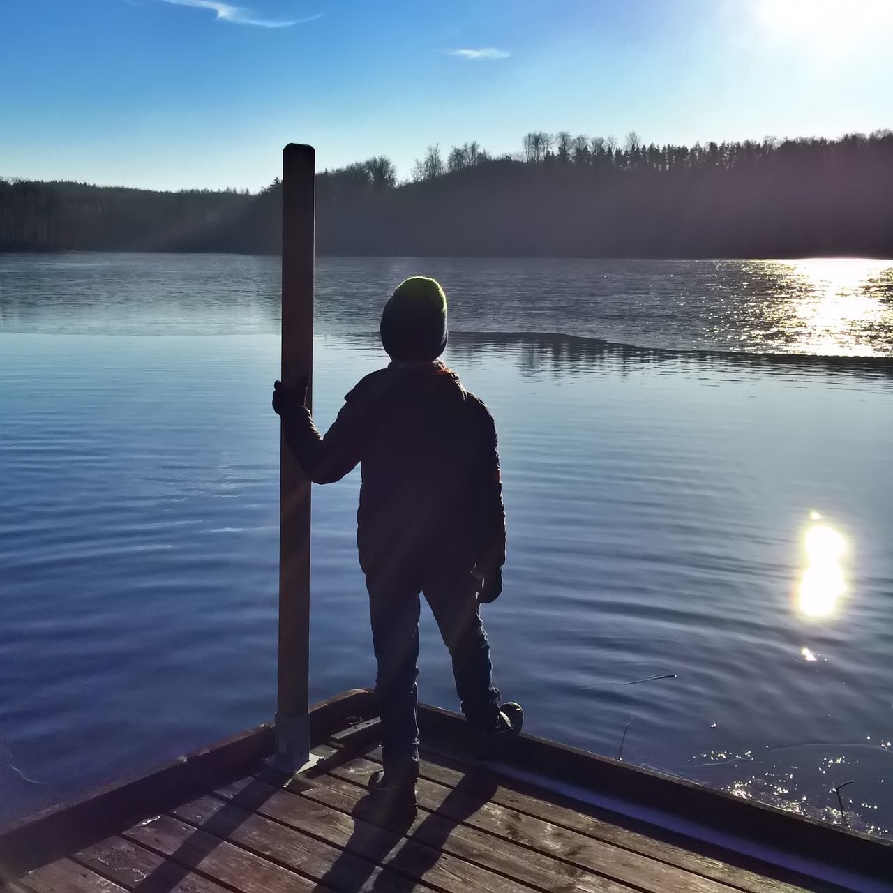 water, rear view, lake, full length, lifestyles, leisure activity, pier, tranquility, standing, tranquil scene, scenics, sky, beauty in nature, nature, reflection, men, sunlight, railing