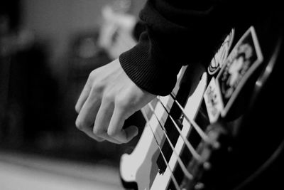 Cropped hand playing guitar