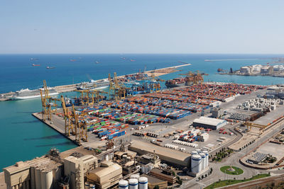 High angle view of city by sea against clear sky