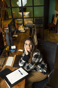 Portrait of smiling businesswoman sitting at office