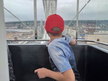 Man looking at cityscape seen through window