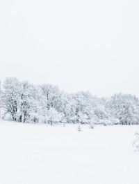 Scenic view of snow covered landscape against clear sky