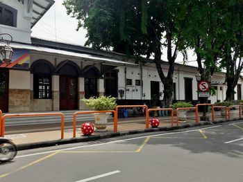 Cars on road by buildings in city