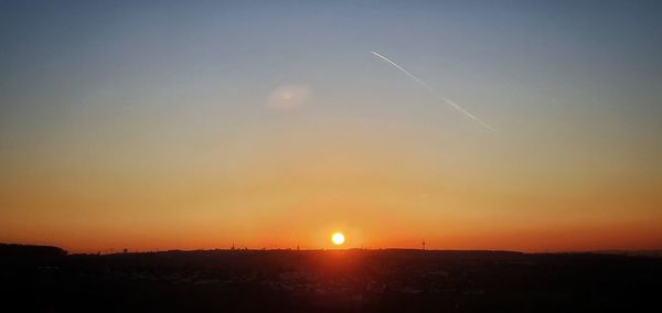 Silhouette landscape against sky during sunset