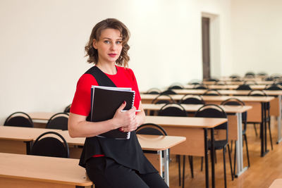 Professional woman teacher working at empty auditorium of high school or college