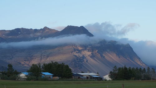 Scenic view of rocky mountains against sky during foggy weather