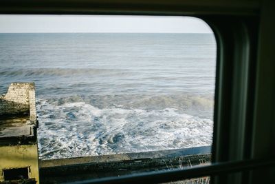 Scenic view of sea seen through window