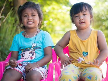 Portrait of a smiling girl sitting outdoors