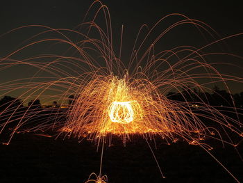 Firework display against sky at night