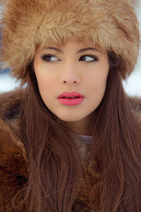 Close-up portrait of young woman in winter