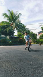 Man riding bicycle on road