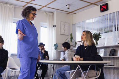 Doctor talking to patient in waiting room