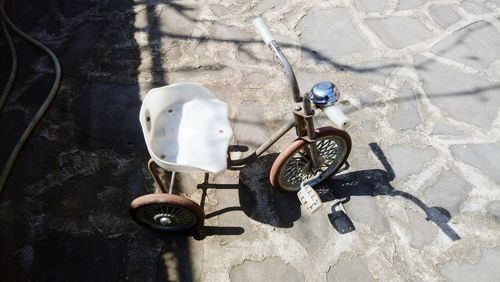 High angle view of toy tricycle on footpath