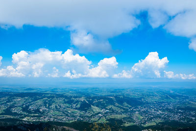 Aerial view of landscape against blue sky