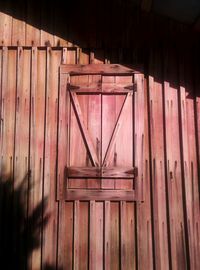 Low angle view of closed window on wooden building