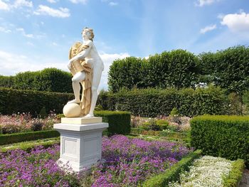 Statue in park against sky