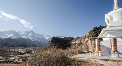 Panoramic view of building and mountains against sky