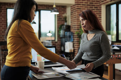 Side view of woman working at office