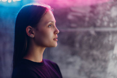 Thoughtful young woman looking away