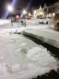 Snow on illuminated street at night during winter