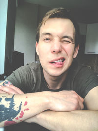 Portrait of young man sitting at home