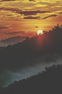 Scenic view of silhouette mountains against sky during sunset