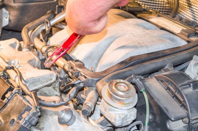 Close-up of mechanic repairing car