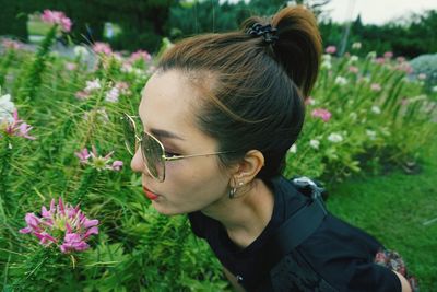 Close-up of woman smelling flowers